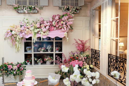 Wallpaper Mural Street terrace cafe with flowers bouquets. Beautiful floral interior decoration on a vintage building facade with pastel flowers and blooming arrangements around a window. Torontodigital.ca