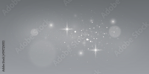 White sparkling star light with glowing particles and soft lens flare on gray background.