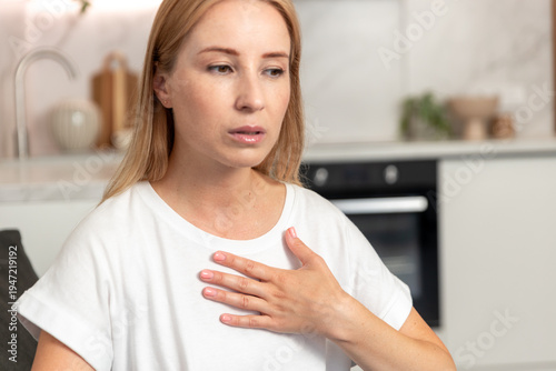 Free Download Woman struggles with discomfort in the living room due to hot summer weather - GFXLoad