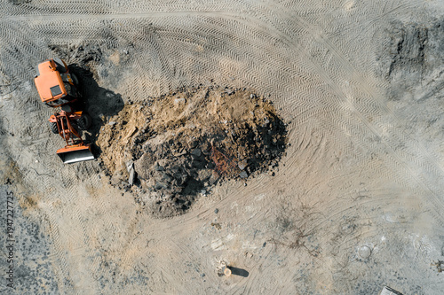 loader near a pile of sand top view