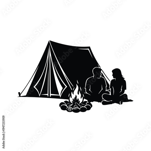 Young couple sitting by campfire near camping tent night silhouette