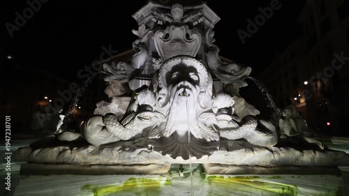 The symmetrical grandeur of the Pantheon Fountain in Piazza della Rotonda. The video highlights the intricate marble carvings of mythical sea creatures and the central obelisk base.