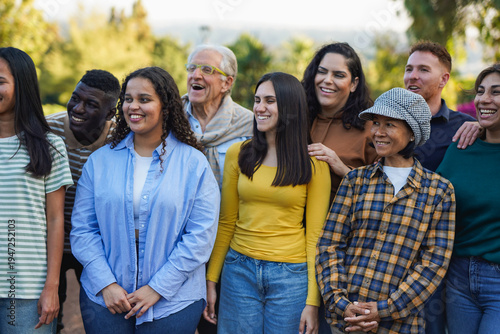 Crowd of multi generational people having fun together at park - Multiracial community, social gathering and diversity concept