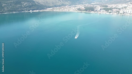 The speedboat moves quickly on the smooth surface of the incredible beauty of the sea