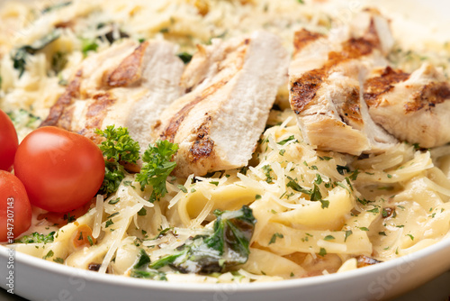 Grilled chicken Alfredo pasta with parmesan cheese