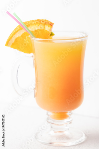 Layered orange citrus cocktail with orange slice garnish