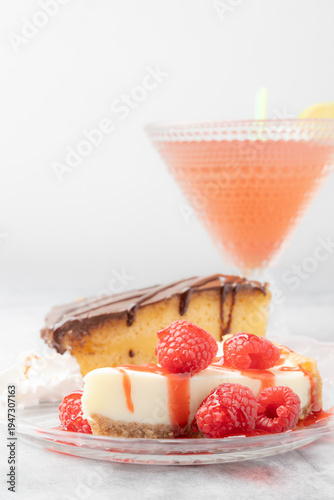 Raspberry cheesecake and Boston cream cake dessert with cocktail