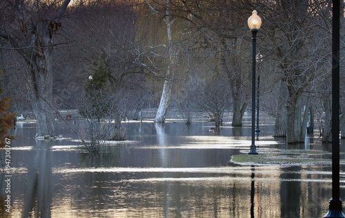 The river flooded the sidewalk and trees on Grand Ledge, Michigan