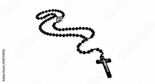 A black rosary with a silver crucifix on a white background