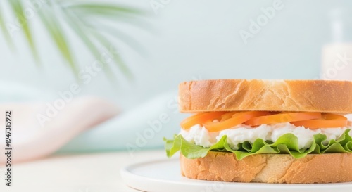 Whisked sandwich, creamy filling, fresh lettuce, orange topping on plate. Whisked sandwich includes soft bread, delicate whipped ingredients, crisp greens, representing new culinary ideas.