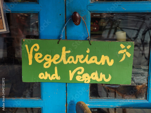 Handwritten hippy style sign outside vegetarian and vegan cafe and restaurant
