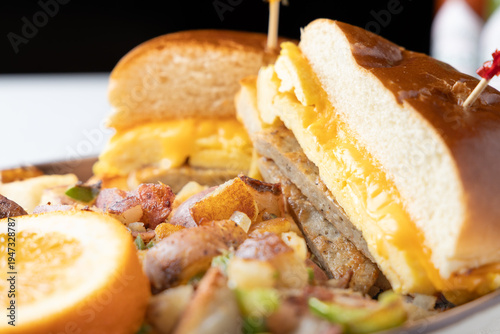 Sausage egg and cheese breakfast sandwich with breakfast potatoes