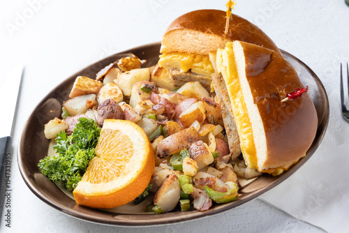 Sausage egg and cheese breakfast sandwich with home fries