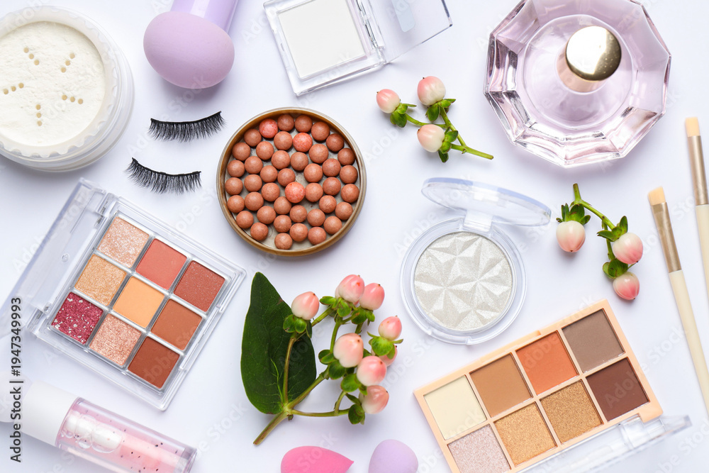 Fototapeta premium Spring composition with different makeup products and flowers on white background, flat lay