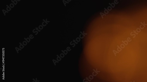 Abstract warm light bokeh gently flows creating tender cinematic mood. Perfect overlay for smooth transitions dreamy backgrounds and romantic video compositions.