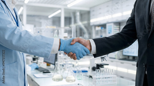 handshake between a scientist in a lab coat and a businessman in a suit representing medical research partnership pharmaceutical investment and healthcare business deal in a laboratory