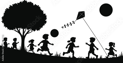 Silhouette of children running and flying a kite under a tree with large black circles in the sky