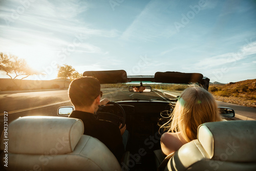 Couple driving in convertible