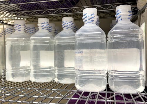 Plastic medical containers with liquid stored in hospital supply room