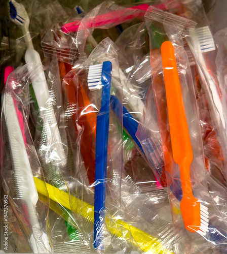 Disposable toothbrushes in sterile packaging stored in healthcare supply container
