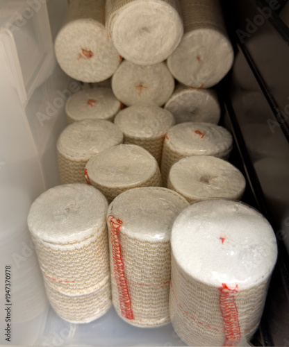 Rolled elastic medical bandages stored in hospital supply container