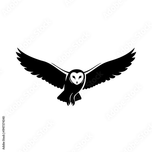 Graceful black owl in mid-flight with outstretched wings