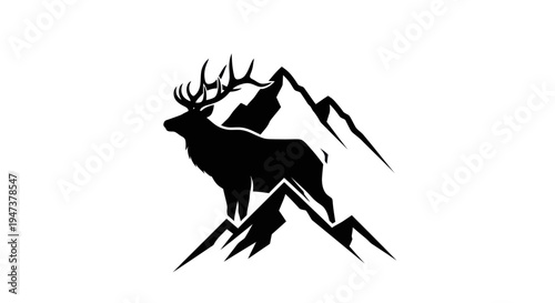Deer silhouette among mountain peaks