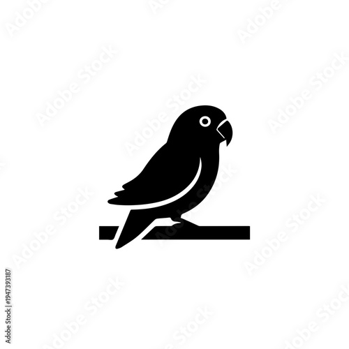 A sleek black silhouette of a bird perched on a thin branch