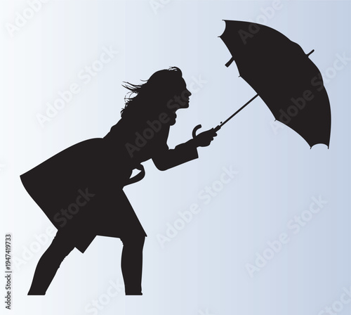 Silhouette of a woman holding an umbrella in the wind