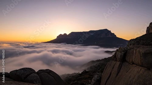 Mountain peak above the clouds sunrise.