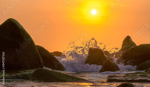 Wallpaper Mural Sunrise landscape at tropical beach. The warm golden light of illuminating the sea spray creates a striking silhouette of the rocks against the glowing sky Torontodigital.ca