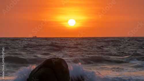 Wallpaper Mural Sunrise landscape at tropical beach. The warm golden light of illuminating the sea spray creates a striking silhouette of the rocks against the glowing sky Torontodigital.ca