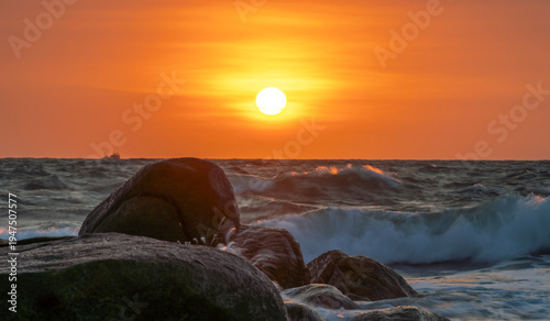 Wallpaper Mural Sunrise landscape at tropical beach. The warm golden light of illuminating the sea spray creates a striking silhouette of the rocks against the glowing sky Torontodigital.ca