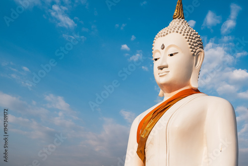 Photography Serene white Buddha statue against a clear blue sky, symbol of peace and Buddhism