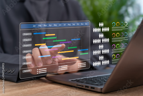 Businessman pointing at project schedule online, Leading team planning, Managing workflow, Team building Organizing tasks and people efficiently for continuous improvement, productivity and success