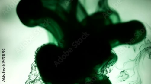 Dark Green Ink Cloud Dissolving in Water Abstract Motion.