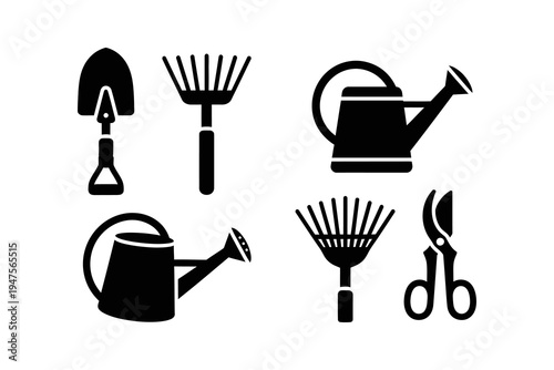Collection of gardening tools including watering cans, rakes, a shovel, and pruning shears
