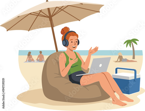 Woman works on laptop under umbrella at beach with cooler nearby