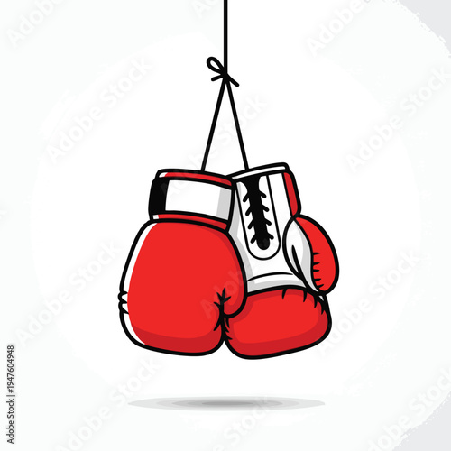 A pair of red and white boxing gloves hang by a string