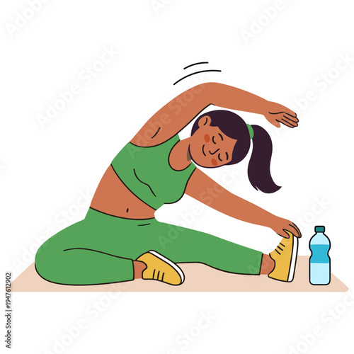 A woman wearing a green sports outfit stretches on the floor next to a water bottle