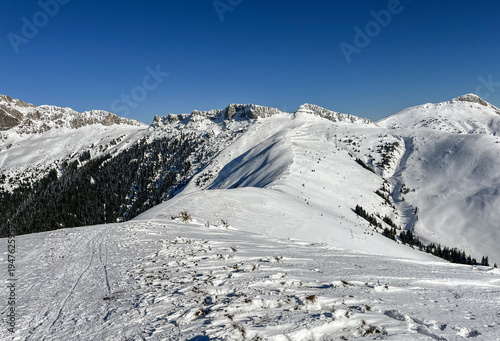 snow covered mountains, view from Bucsa Peak, Bucegi Mountains, Romania 