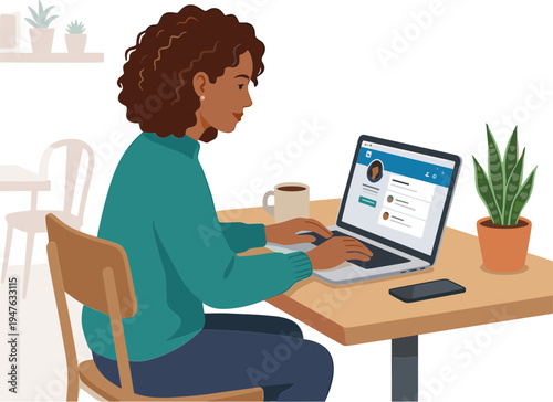 A woman sits at a table working on her laptop with a plant nearby indoors.