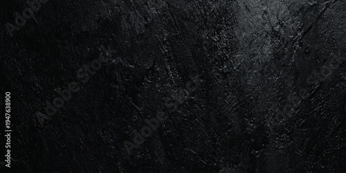 Abstract black wall texture background with rough slate surface deep shadows, highlights on jagged edges.