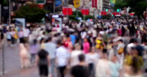Cinematic daytime time-lapse of pedestrian street in central Shanghai during Golden Week and National Day holiday surge. Overhead perspective features defocused view to avoid recognizable faces.