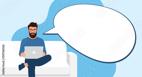 Man working comfortably on his laptop while sitting on a sofa next to a large blank speech bubble for communication concepts.