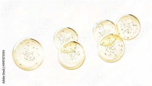 Golden oil capsules with bubbles isolated on white background pure vitamin supplement droplets natural skincare essence healthy nutrition concept pharmaceutical ingredient glossy