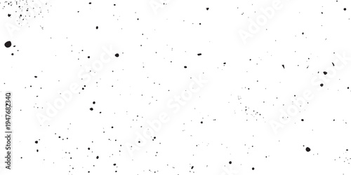 Black ink splatters and grainy dust particles on a white background