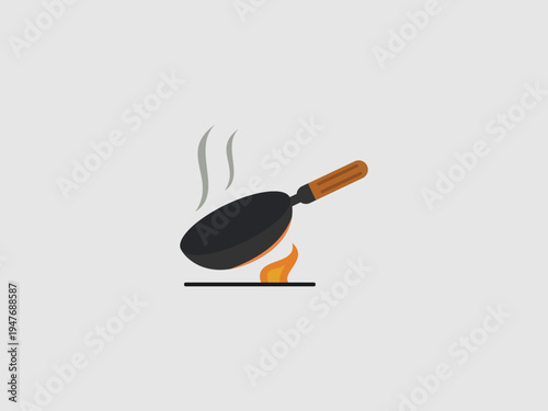 A black stir fry wok with a wooden handle shown tilted over an orange flame with rising steam