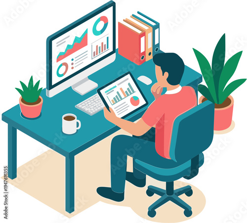 A man sits at a desk analyzing data on a computer and tablet in an office.