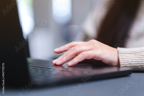 Photos Closeup image of a woman hand working and touching on laptop computer touchpad